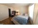 Bright bedroom featuring hardwood floors, a comfortable bed, and a closet with ample storage space at 6806 Blackstone Pl # 12, Mableton, GA 30126