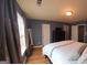 Cozy main bedroom with neutral tones, hardwood floors, and a large window for natural light at 6806 Blackstone Pl # 12, Mableton, GA 30126