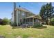 Expansive backyard featuring a screened porch and outdoor patio with a table and chairs at 750 Gates Ln, Alpharetta, GA 30022
