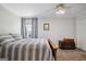 Cozy bedroom featuring soft gray bedding and neutral decor with natural light from the window at 750 Gates Ln, Alpharetta, GA 30022