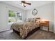 Cozy bedroom featuring a window offering abundant natural light and a wooden headboard at 750 Gates Ln, Alpharetta, GA 30022