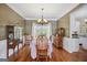 Dining room with hardwood floors, a chandelier, a vintage cabinet and large window for natural light at 750 Gates Ln, Alpharetta, GA 30022