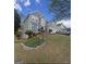 Charming two-story home with landscaped yard, stone accents, and a two-car garage on a sunny, clear day at 750 Gates Ln, Alpharetta, GA 30022
