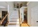 Inviting foyer with hardwood floors, a staircase with black iron railings, and a view into the dining area at 750 Gates Ln, Alpharetta, GA 30022