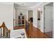 Upstairs hallway with hardwood floors, detailed trim, and views of the bathroom and possible bedroom or bonus room at 750 Gates Ln, Alpharetta, GA 30022