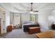Spacious main bedroom with a tray ceiling, ceiling fan, two windows, and neutral carpeting at 750 Gates Ln, Alpharetta, GA 30022