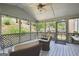 Relaxing screened-in porch with comfortable wicker furniture, a ceiling fan, and a view of the serene backyard at 750 Gates Ln, Alpharetta, GA 30022