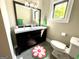 Bathroom featuring a double sink vanity with a large mirror, a toilet, and a window at 727 Channing Dr, Atlanta, GA 30318