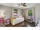 Well-lit bedroom with hardwood floors, two windows, and charming decor at 727 Channing Dr, Atlanta, GA 30318