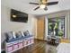 Bright bedroom features hardwood floors, bench seating, and a large sunny window overlooking the backyard at 727 Channing Dr, Atlanta, GA 30318