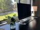 Desk area with sleek black desk, modern computer, and natural light at 727 Channing Dr, Atlanta, GA 30318