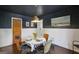 Dining room boasts modern decor with a decorative table, hardwood floors, and a dark ceiling at 727 Channing Dr, Atlanta, GA 30318