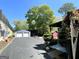 Driveway with two-car garage, outdoor art and a red shed at 727 Channing Dr, Atlanta, GA 30318