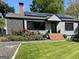 Charming home featuring a well-manicured lawn, brick steps, stone accents, and solar panels at 727 Channing Dr, Atlanta, GA 30318