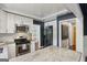 Bright kitchen with stainless steel appliances, white cabinets, and a view into other rooms at 727 Channing Dr, Atlanta, GA 30318