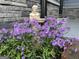 Beautiful landscaping around statue enhances the curb appeal and charm of this home's exterior at 727 Channing Dr, Atlanta, GA 30318
