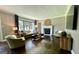 Spacious living room boasts a large window, fireplace, and hardwood floors throughout at 727 Channing Dr, Atlanta, GA 30318