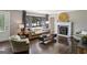 Bright living room featuring hardwood floors, a fireplace, and large windows with backyard views at 727 Channing Dr, Atlanta, GA 30318