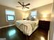 Main bedroom featuring a ceiling fan, side tables with lamps, and dark wood floors at 727 Channing Dr, Atlanta, GA 30318