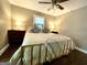 Comfortable main bedroom boasts a ceiling fan, side tables with lamps, and hardwood floors at 727 Channing Dr, Atlanta, GA 30318