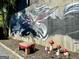 Outdoor art on retaining wall along driveway with small table and lawn ornaments at 727 Channing Dr, Atlanta, GA 30318