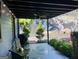 Exterior view of covered patio, outdoor grill, yard, and decorative wall art at 727 Channing Dr, Atlanta, GA 30318