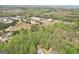 A cozy home surrounded by lush greenery, with commercial buildings in the distance at 6435 Philips Creek Dr, Cumming, GA 30041