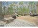 A spacious back deck with outdoor seating and grill area overlooking the backyard at 6435 Philips Creek Dr, Cumming, GA 30041