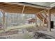 Backyard view featuring a storage shed, wooden stairs to deck, and wooded surroundings at 6435 Philips Creek Dr, Cumming, GA 30041