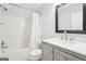 This bathroom features a shower-tub combo with white shower curtain and a modern sink and vanity at 6435 Philips Creek Dr, Cumming, GA 30041