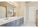 Bathroom features double vanity, large mirror, and neutral color palette at 6435 Philips Creek Dr, Cumming, GA 30041