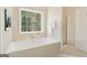 Bright bathroom with a large soaking tub, separate shower, and natural light at 6435 Philips Creek Dr, Cumming, GA 30041