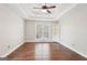 Spacious bedroom with hardwood floors, ceiling fan, and natural light at 6435 Philips Creek Dr, Cumming, GA 30041