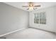 Bright bedroom features carpeted flooring, a neutral color palette, and large window for natural light at 6435 Philips Creek Dr, Cumming, GA 30041