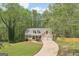 Charming home with a two-car garage, dormer windows, and a well-manicured lawn surrounded by lush trees at 6435 Philips Creek Dr, Cumming, GA 30041