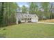 Home with a well manicured lawn, driveway, two car garage, front porch and wooded surroundings at 6435 Philips Creek Dr, Cumming, GA 30041