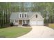 Inviting home with green lawn, attached two-car garage, and dormer windows at 6435 Philips Creek Dr, Cumming, GA 30041