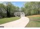 Charming two-story home featuring a welcoming front porch, attached two-car garage, and a long curved driveway at 6435 Philips Creek Dr, Cumming, GA 30041