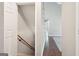 An open view of the hallway features hardwood floors, a staircase, and natural light streaming through a window at 6435 Philips Creek Dr, Cumming, GA 30041