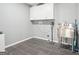 This laundry room includes tile floors, washer and dryer hookups, a utility sink, and ample storage space at 6435 Philips Creek Dr, Cumming, GA 30041