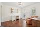 Bright living room offers hardwood floors, desk and chair area, and two windows providing natural light at 6435 Philips Creek Dr, Cumming, GA 30041