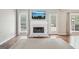 Cozy living room features a fireplace with marble surround, flanked by windows for natural light at 6435 Philips Creek Dr, Cumming, GA 30041