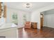 Bright living room offers hardwood floors, comfortable sitting area and two windows providing natural light at 6435 Philips Creek Dr, Cumming, GA 30041