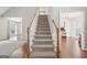 Carpeted staircase connects living spaces in this bright, open-concept home at 6435 Philips Creek Dr, Cumming, GA 30041
