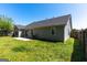 View of backyard with patio and a partially fenced yard in a residential neighborhood at 6844 Saganaw Dr, Rex, GA 30273