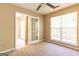 Bedroom featuring neutral walls and carpet, a window with blinds and a glass door leading to another room at 6844 Saganaw Dr, Rex, GA 30273