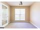 Bedroom featuring neutral walls and carpet, a window with blinds and a glass door with white trim at 6844 Saganaw Dr, Rex, GA 30273