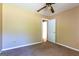 Bedroom featuring neutral walls and carpet, ceiling fan, and white door leading to another room at 6844 Saganaw Dr, Rex, GA 30273