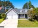 Charming one-story home featuring a two-car garage and well-maintained front yard at 6844 Saganaw Dr, Rex, GA 30273