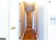 Hallway with hardwood floors and access to the kitchen at 6844 Saganaw Dr, Rex, GA 30273